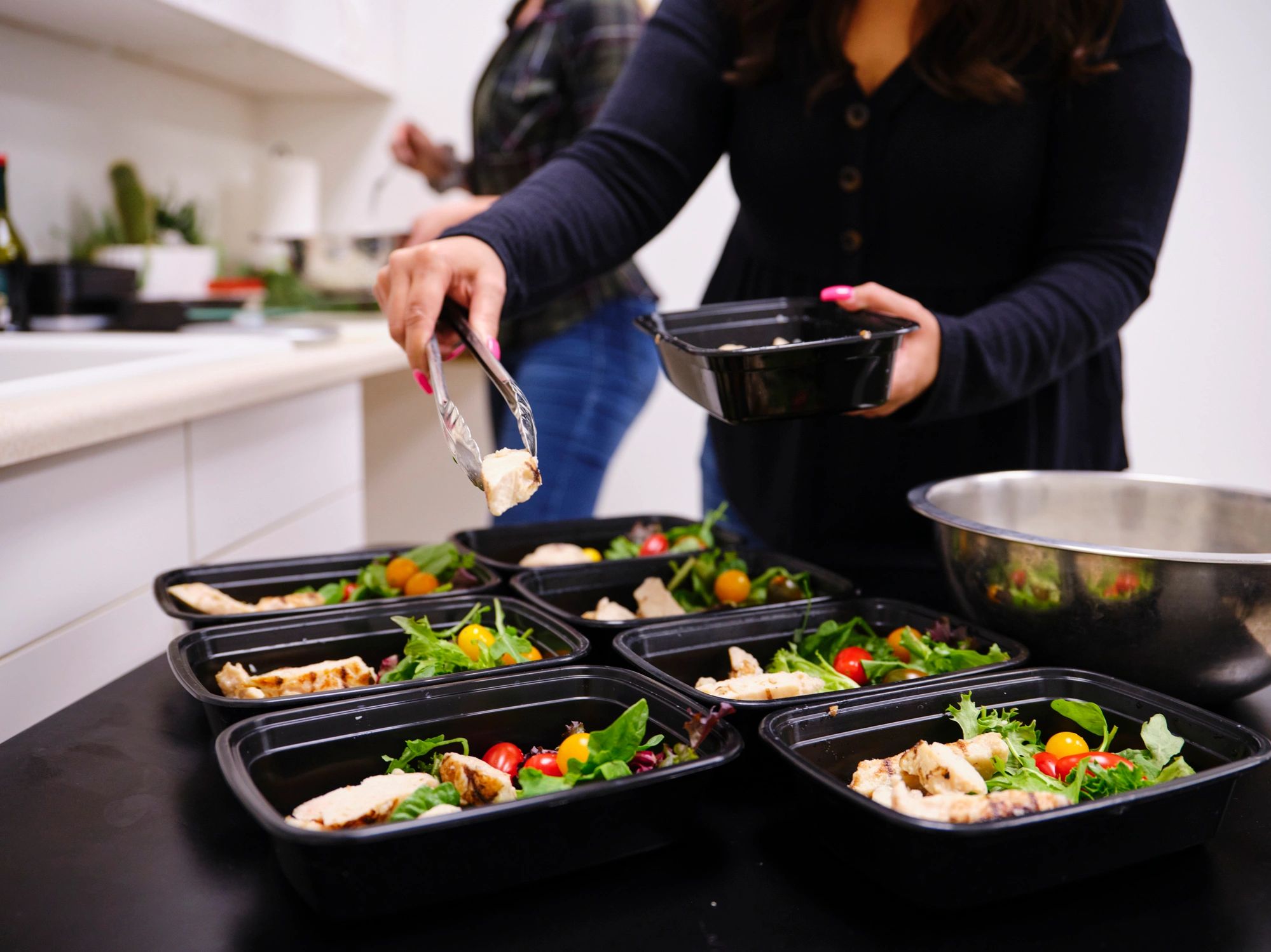 Woman preparing healthy meals in a home kitchen