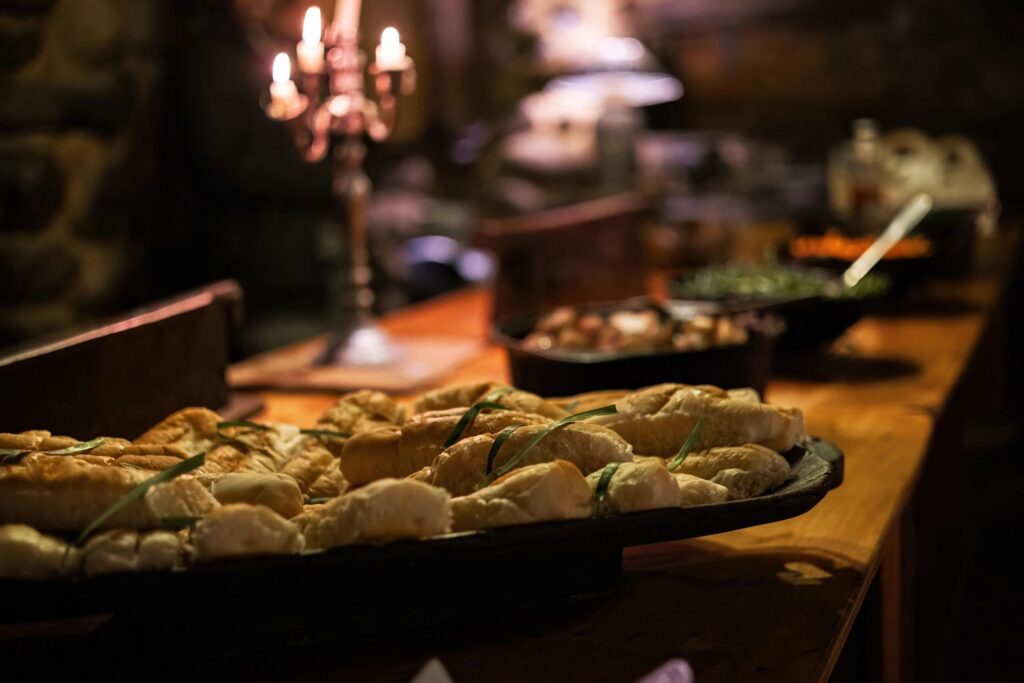 Bread and Food Display at Buffet Table in Candlelight