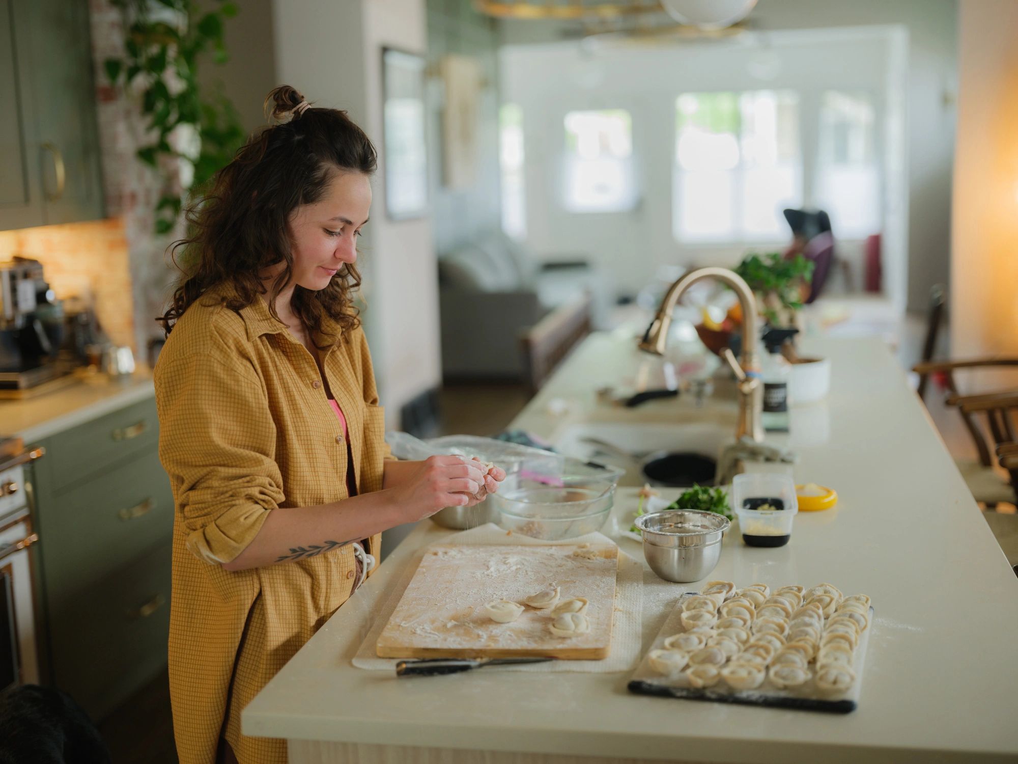 Woman making dumplings at her domestic kitchen