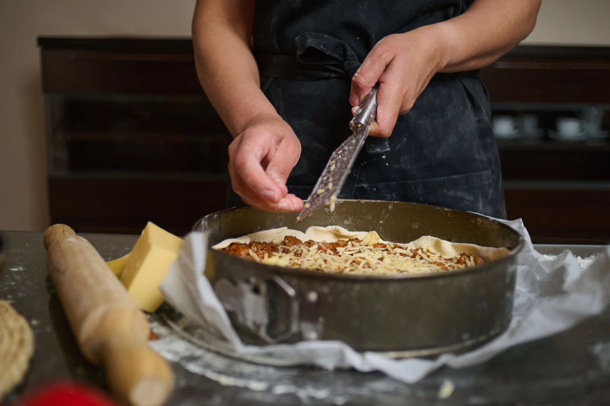 Hands preparing a homemade pie in a kitchen