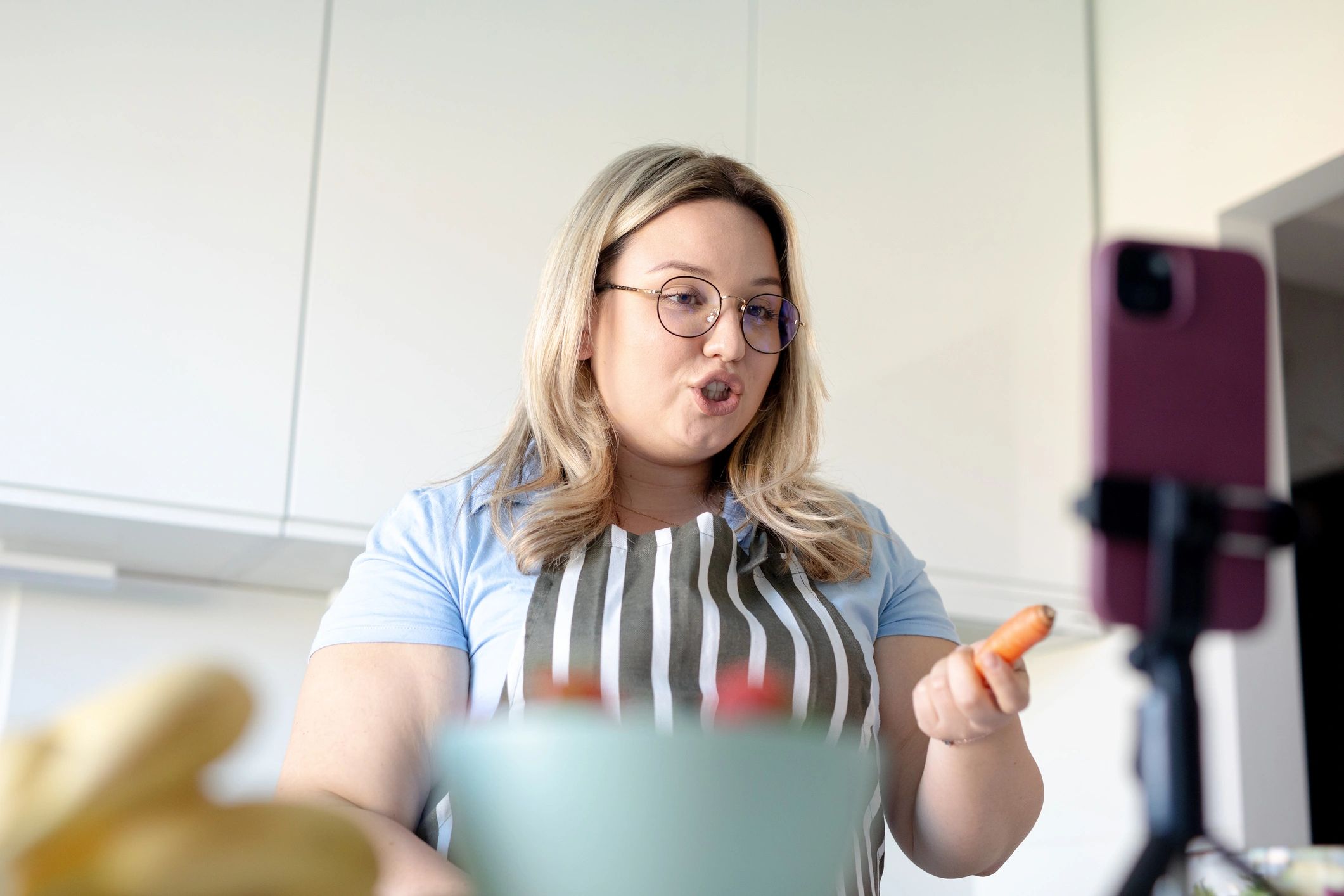Woman vlogging healthy cooking recipe in kitchen -stock photo